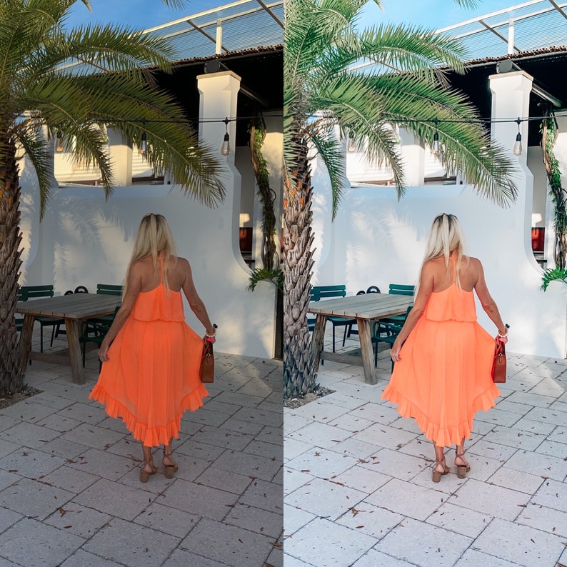 May include: A woman wearing a bright orange dress with a ruffled hem stands in front of a white building with palm trees. She is holding a brown handbag.