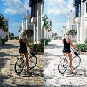 May include: A woman in a black tank top and shorts rides a white bicycle down a street lined with white buildings. The street is paved with stone and there are palm trees on either side.