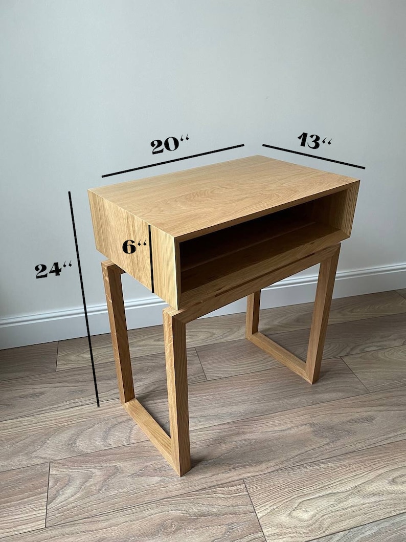 May include: A wooden end table with a shelf and a drawer. The table is 24 inches tall, 20 inches wide, and 13 inches deep. The shelf is 6 inches deep.