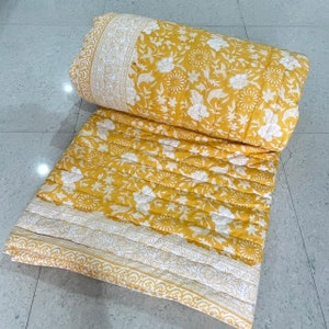 sunny warmth for winter: yellow flower hand block print quilt, hand-stitched for cozy nights. elevate your bedding with artisan craftmanship