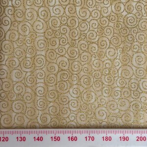 May include: Close-up of a fabric featuring a repeating pattern of gold swirls on a beige background. The fabric has a textured appearance, and the swirls are outlined with a metallic gold thread. The design is elegant and decorative.