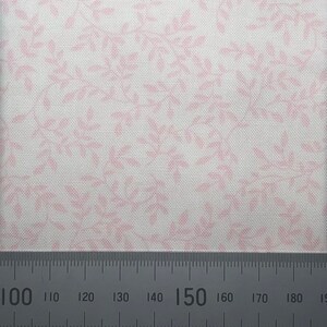 May include: White fabric with a delicate pink floral pattern. The fabric is shown with a ruler measuring 150 inches.