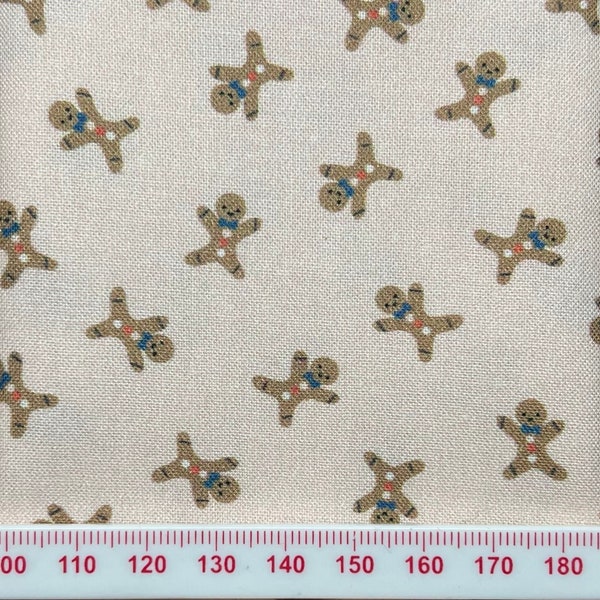 Tiny Gingerbread men on palest pink background. Great for patchwork and small scale crafts.