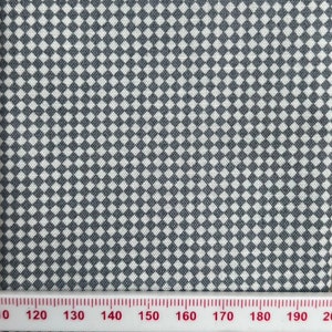 May include: White fabric with a grey and white checkered pattern. The fabric is measured with a ruler in inches.
