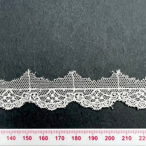 Pale cream lace with delicate details. Perfect for small scale crafts.