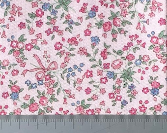 Flowers and ribbons on pink cotton