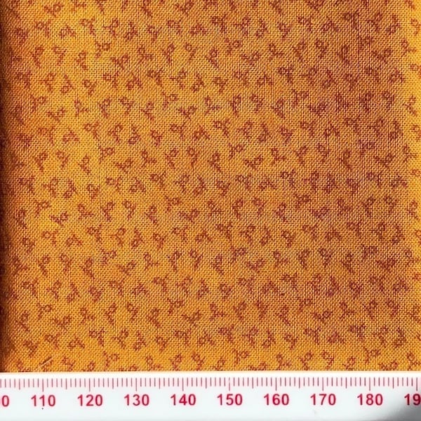 Ochre cotton print with tiny symbols. Perfect for small scale crafts.