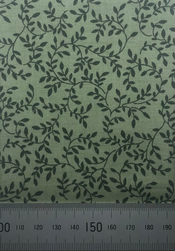 Dark green vines on green cotton. Small scale cotton print