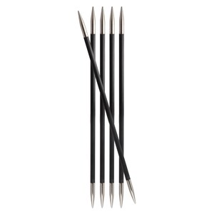 May include: A set of six knitting needles. The needles have black shafts and silver-colored tips. One needle is angled across the others. The needles are arranged vertically against a white background.