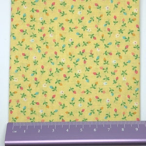 Mixed colour rosebud on yellow cotton fabric