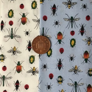 May include: Two fabric swatches with a repeating pattern of insects and other small objects. The left swatch is white with a light blue insect pattern. The right swatch is light blue with a white insect pattern. A British one pound coin is placed between the two swatches.