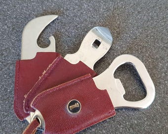 Vintage set of bottle openers, stainless steel in little leather covers.