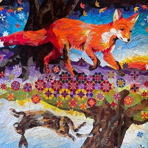 May include: A colorful quilt featuring a red fox with a white chest and a brown rabbit. The quilt is made of various fabrics and patterns, including stars, flowers, and geometric shapes.