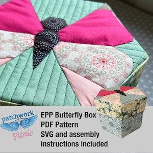 May include: A green, pink, and white patchwork butterfly box with a floral design. The box is made with English paper piecing (EPP) and includes a PDF pattern, SVG file, and assembly instructions.