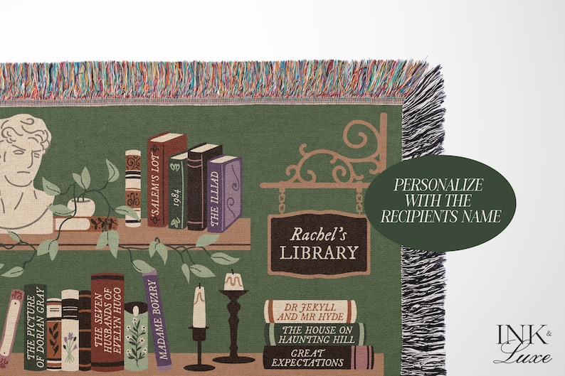 May include: A green and brown woven tapestry with a bookshelf design. The bookshelf is filled with books with titles like "The Picture of Dorian Gray", "Salem's Lot", and "The Illiad". The tapestry also features a sign that says "Rachel's Library".