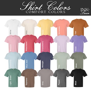 May include: A chart of 20 different t-shirt colors, with each color displayed on a t-shirt. The colors include white, ivory, butter, terracotta, yam, blossom, watermelon, crunchberry, orchid, violet, chambray, blue jean, midnight, bay, moss, light green, espresso, grey, pepper, and black. The chart is titled "Shirt Colors" and "Comfort Colors" with the text "INK* Luxe" in the top right corner.