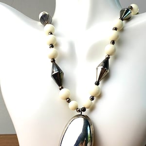 Vintage Dauplaise Lucite off white and silver plated 34” long  Necklace oval pendant