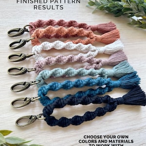 May include: A collection of handmade macrame keychains in various colors, including pink, orange, white, mauve, teal, blue, and navy. Each keychain features a twisted rope design, a metal clasp, and a matching tassel. The text "FINISHED PATTERN RESULTS" and "CHOOSE YOUR OWN COLORS AND MATERIALS TO WORK WITH" are visible.