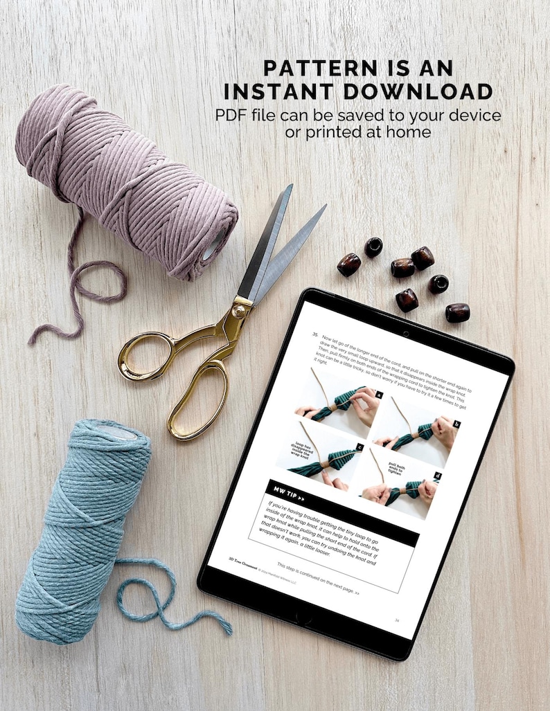 May include: A tablet displaying a digital download pattern for a macrame project. The pattern includes instructions and images. The tablet is on a wooden surface with two spools of cord, a pair of scissors, and wooden beads.