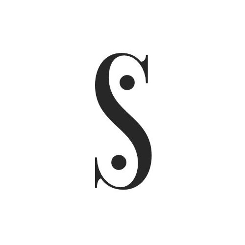 May include: Black and white stylized letter S with two black dots inside the letter.