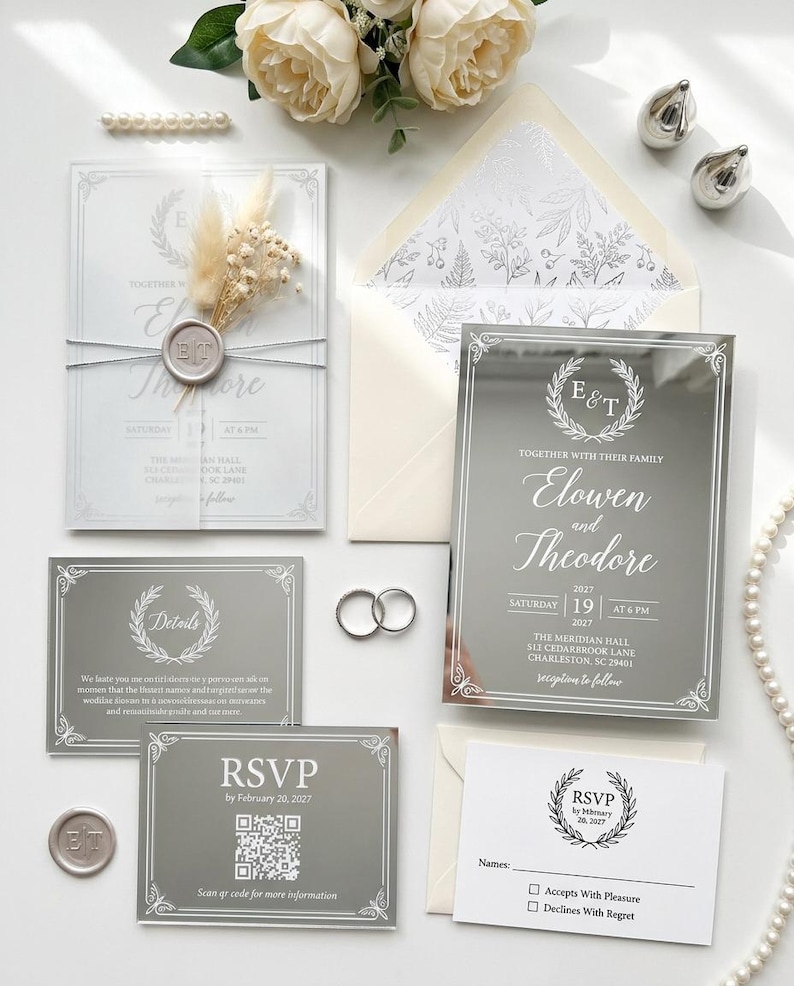 Hand-pressed gold wax seal with couple initials on a vellum wrapped wedding invitation