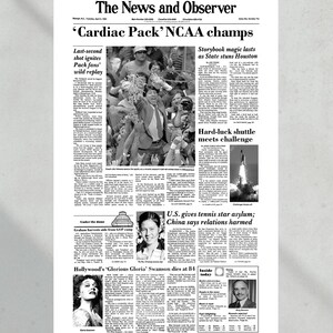 May include: A black and white newspaper front page with the headline "'Cardiac Pack' NCAA champs". The article discusses the University of North Carolina's victory in the NCAA men's basketball championship. Other articles include a story about the space shuttle Challenger, a story about a tennis player seeking asylum in the United States, and an obituary for actress Gloria Swanson.