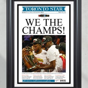 May include: A Toronto Star newspaper front page headline reads "We The Champs!" with a photo of the Toronto Raptors basketball team holding the NBA championship trophy. The score of the game is shown as 114-110.