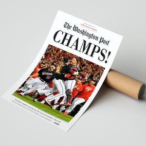 May include: A newspaper headline from The Washington Post reads "CHAMPS!" with a photo of the Washington Nationals baseball team celebrating their World Series victory. The headline also reads "WORLD SERIES CHAMPIONS".