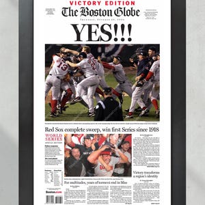 May include: Framed print of The Boston Globe newspaper from October 28, 2004, with the headline "YES!!!" and a photo of the Red Sox celebrating their World Series win. The text reads "Red Sox complete sweep, win first Series since 1918."