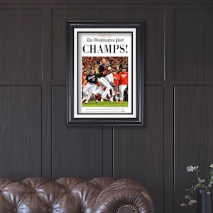 May include: A framed newspaper print of a baseball team celebrating their victory. The headline reads "The Washington Post CHAMPS!"