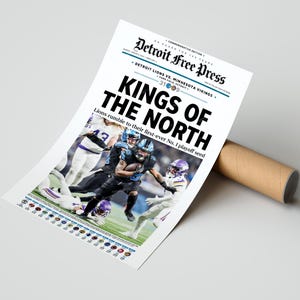 May include: A commemorative edition Detroit Free Press newspaper print. The headline reads "KINGS OF THE NORTH" with a photo of a football game. The text "Detroit Lions vs. Minnesota Vikings" is also visible. The print is rolled up with a brown cardboard tube.