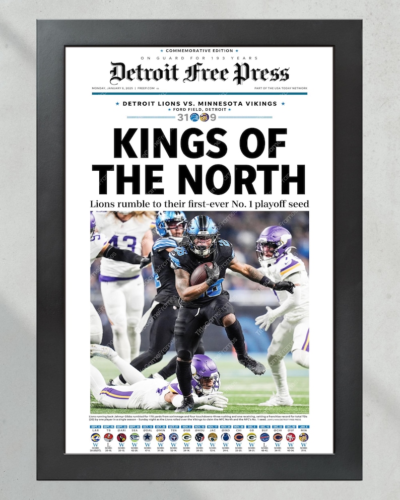 May include: Framed Detroit Free Press newspaper front page with the headline "KINGS OF THE NORTH." The image features a football game with players in blue and purple uniforms. The text reads "Detroit Lions vs. Minnesota Vikings" and "Lions rumble to their first-ever No. 1 playoff seed."