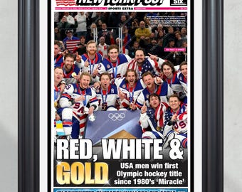 Ingelijste krant van de USA Hockey “Rood, Wit & Goud” kampioenen van 2026