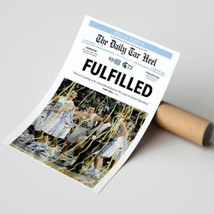 May include: A newspaper headline reads "FULFILLED" with the score of a basketball game, 89 to 72, and the text "Now we're going to be remembered forever. We want to become legendary." A photo of a basketball team celebrating their victory is below the headline.
