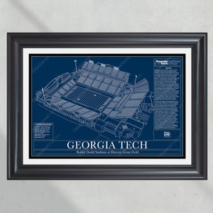 May include: Framed art print featuring a blueprint of Georgia Tech's Bobby Dodd Stadium at Historic Grant Field. The stadium is rendered in white lines on a navy blue backdrop. The print includes the text "GEORGIA TECH" and stadium information.