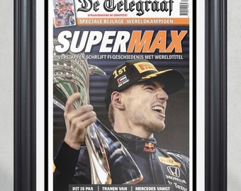 May include: A newspaper front page with the headline "SUPERMAX" and a photo of Max Verstappen holding a trophy. The headline reads "Verstappen writes F1 history with world title". The newspaper is called "De Telegraaf" and the date is December 13, 2021.