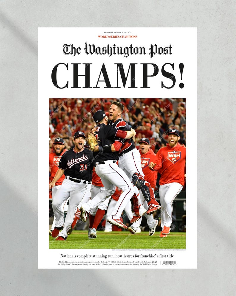 May include: A Washington Post newspaper headline announcing the Washington Nationals as World Series Champions. The headline reads "CHAMPS!" and features a photo of the team celebrating their victory. The team is wearing their red and white uniforms and are jumping and hugging each other. The photo is taken from a low angle, giving a dynamic perspective of the celebration.