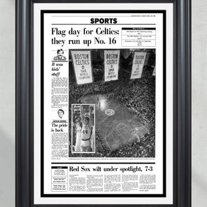 May include: Black and white framed print of a newspaper page with the headline "Flag day for Celtics: they run up No. 16." The image includes photos of basketball players and the text "BOSTON CELTICS 1968 WORLD CHAMPIONS" and "1969 WORLD CHAMPIONS."