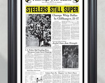 May include: A vintage Pittsburgh Post-Gazette newspaper headline from January 19, 1976, announcing the Pittsburgh Steelers' Super Bowl victory over the Dallas Cowboys. The headline reads "STEELERS STILL SUPER" and "Champs Whip Dallas In Cliffhanger, 21-17".