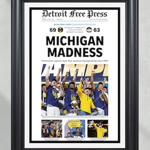 May include: Framed print of the Detroit Free Press commemorating the NCAA Final Four. The headline reads "Michigan Madness" with the score 69-63. The image features a team celebrating their victory. The frame is black.