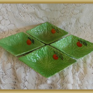 May include: Set of four green ceramic salad bowls with a lettuce leaf design and a single red tomato on each bowl.