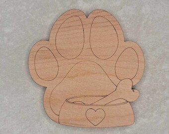 May include: Wooden cutout of a dog paw print with a dog bowl and bone inside. The bowl has a heart on the front.