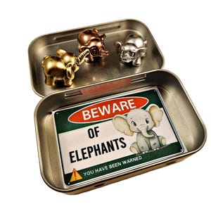 May include: A silver metal tin with a warning sign that reads "Beware of Elephants You Have Been Warned". Inside the tin are three miniature elephant figurines, one gold, one silver, and one copper.