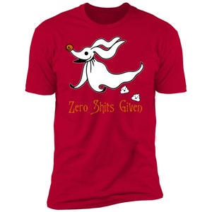May include: Red t-shirt featuring a white cartoon dog wearing a pumpkin on its head and the text "Zero Shits Given".
