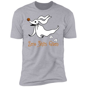 May include: A grey t-shirt featuring a white cartoon ghost dog with a pumpkin face and the text "Zero Shits Given".