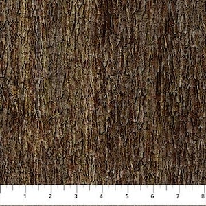 May include: Close-up of a fabric with a textured bark pattern in shades of brown and green. The fabric has vertical lines and a rough surface, resembling tree bark. A ruler is at the bottom, showing measurements in inches.
