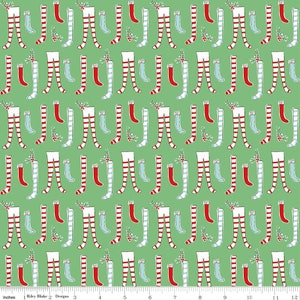 May include: A green fabric with a repeating pattern of white and red striped stockings, blue socks, and red stockings with white trim. The stockings are all in a standing position with the tops of the stockings folded over.