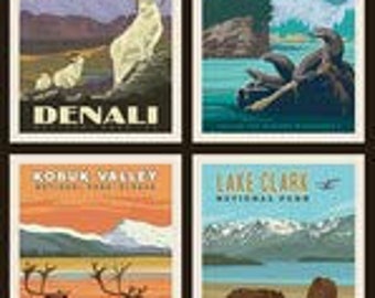 May include: Four vintage-style travel posters featuring national parks in Alaska. The top left poster shows a mountain range with two white mountain goats. The top right poster shows a lake with a bird perched on a log. The bottom left poster shows a river with two caribou. The bottom right poster shows a lake with two brown bears.