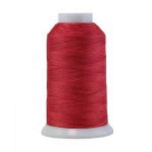 May include: A spool of bright red thread for sewing or embroidery.