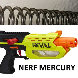 May include: A yellow and black Nerf Rival Mercury K26 blaster with an orange barrel. The blaster has a black handle and a clear plastic window on the side.
